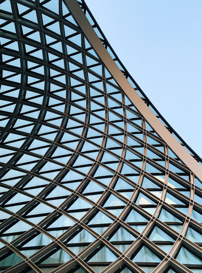 The Art of Drawing Readers In: Your attractive post title goes here Close-up of a futuristic geometric steel and glass architecture with a modern design.